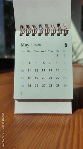 Slow motion footage of flip calendar pages for change months from april to may of the year 2026. concept of planning and starting a new month. 4k vertical.