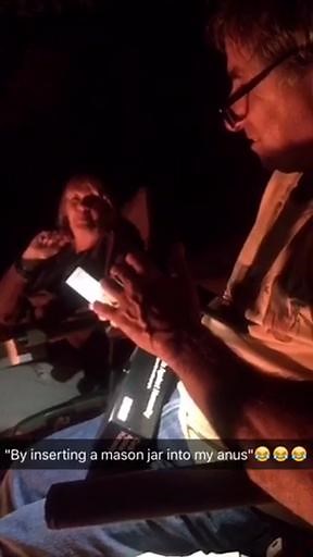 old man plays cards against humanity with younger grandchildren and laughs at cards