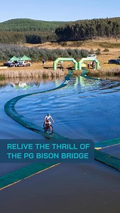 🌱 Trail Tuesday | Relive the Thrill of the PG Bison Bridge Where trail design meets full-blown spectacle (and the occasional splash). Featured in Day 1, and stretching 200 metres across Moss Bank Dam, the PG Bison floating bridge is a moving thrill ride that tests your balance, spikes your heart rate, and brings pure KAP sani2c gees. 🫨 Built with heart by our long-time partner @pg_bison this iconic feature captures what KAP Sani2c is all about: innovation, fun, and trails you’ll talk about for