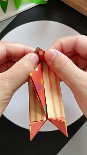 the process of making a toy boat from paper that is folded in such a way
