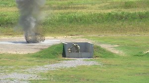 Basic trainees practice throwing at grenade range