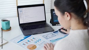 Back rear view of young asian woman, freelance data scientist work remotely at home coding programing on Big data mining, AI data engineering, IT Technician Works on Artificial Intelligence Project.