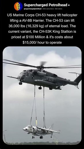 USMC CH-53 helicopter lifting the harrier jet
