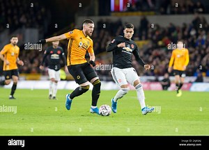 4th January 2020; Molineux Stadium, Wolverhampton, West Midlands, England; English FA Cup Football, Wolverhampton Wanderers versus Manchester United; Matt Doherty of Wolverhampton Wanderers as Andreas Pereira of Manchester United comes in to tackle - Strictly Editorial Use Only. No use with unauthorized audio, video, data, fixture lists, club/league logos or 'live' services. Online in-match use limited to 120 images, no video emulation. No use in betting, games or single club/league/player publi