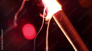 Explosion of firecrackers close-up. Pyrotechnics on a dark background with flashing lights out of focus. Explosion slow motion. Holidays and entertainment. Dangerous entertainment