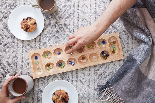 How to play Mancala, one of the oldest board games: rules and strategies