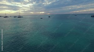 drone shot of a boat sailing through the waters on the island of aruba