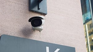 Download CCTV security camera operating on building for free