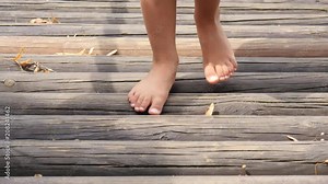 Barefoot legs kid girl play on park playground for children enjoy to be barefooted outdoor
