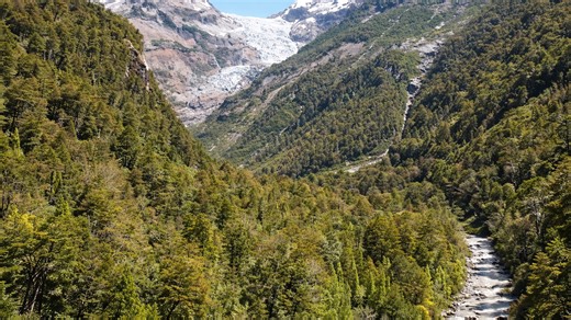 A wild valley beneath a massive glacier