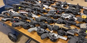 2 men arrested for kidnapping store manager and stealing more than 120 guns, police say