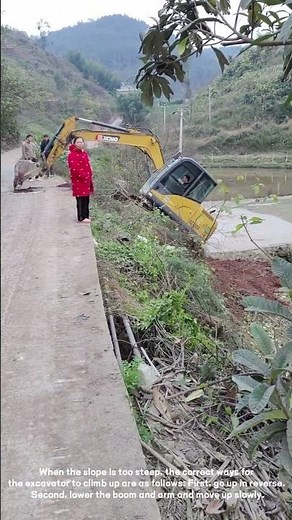 The excavator climbs up the steep slope