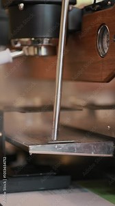 Vertical footage Barista's hand opens the vaporizer on the coffee machine. hot steam is poured into a drip tray. Steam emission from the coffee machine.
