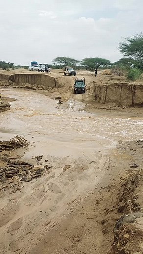 Mud Challenge: Vehicles Navigate Waterlogged Road