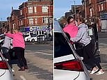 Shocking moment two women pull each other's hair and wrestle in road rage brawl