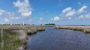 Drone view of the coastal marsh of Wanchese, North Carolina on a sunny day with blue sky