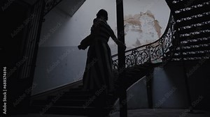 a girl in halloween costume coming to stairs in the old house. She is wearing knee-high leggings,recorded in slow motion, daytime, indoor