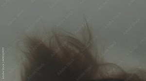 Female brown hair under water in bathtub in slow motion and 4K at 25fps.