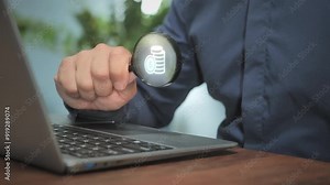 Earning money online concept,person at computer holding magnifying glass searching for making profit on internet,male hand holds magnifier at the laptop screen with pile of money on the lens