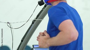 Man athlete going trough the Vo2 Max testing on treadmill in modern sport science lab. triathlete workout testing endurance preparing to the race. Professional sport analyzing