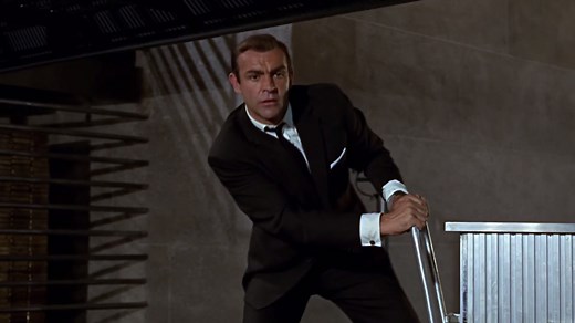 3.9M views · 87K reactions | Bond faces off against Oddjob in the vaults of Fort Knox in GOLDFINGER. The crew weren’t allowed to film in the actual gold depository in the US. Director Guy Hamilton said, “We realised it was probably really dull inside anyhow. So I said to designer Ken Adam, ‘You know, nobody’s ever been in Fort Knox, so we can design anything and nobody can prove us wrong’.” | James Bond 007 | Facebook