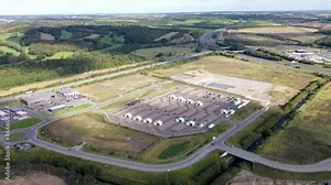 Aerial footage of the Covid-19 drive-through testing site in Leeds West Yorkshire showing the car park testing facilities with coronavirus testing tents