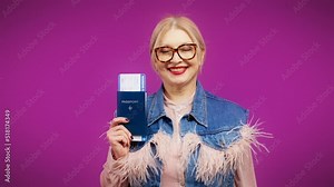 Smiling senior lady holding boarding pass and passport, travel, lifestyle