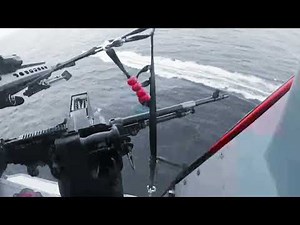 A Coast Guard HITRON MH-65E Dolphin aircrew during drug interdiction operation