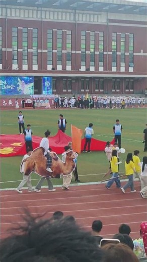 Students march with giant camel cutout during school sports event in Heilongjiang, China