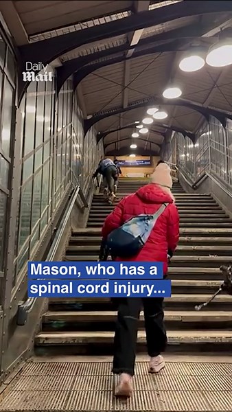 Father carries disabled son up station stairs after elevator outage