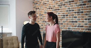 Young man and woman in activewear doing exercise during workout at home. High quality 4k footage