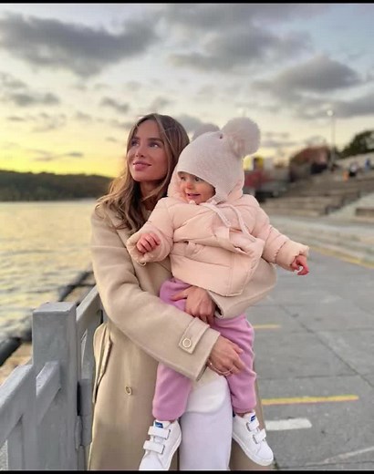 A Serene Sunset Moment by the Water with a Child