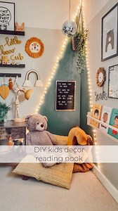 Kids reading nook idea... Creating a kids reading corner doesn't need to cost a penny. I created this one in a lost corner of my little boys bedroom using only what I already had at home... Masking tape a triangular shape in the corner of your kids room and then paint a complementary colour to the kids room decor. Line your triangle with some plug in fairy lights for some magic and sparkle. I shopped my home for cushions from the playroom and nursery and used an ikea storage rack to hold some bo