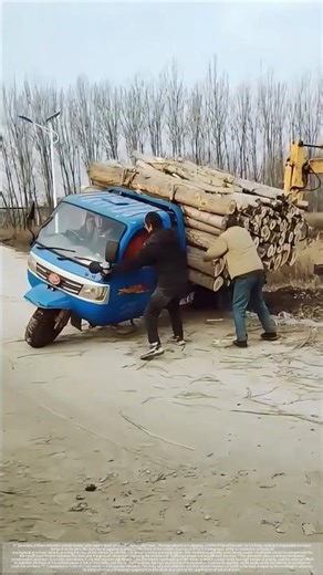 With a push from the excavator, the three-wheeled vehicle loaded with timber was freed.