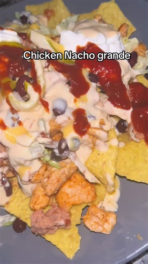 Chicken nacho grande with lettuce,onion,black beans,refried beans,banana peppers,queso cheese,nacho cheese,sour cream and a little salsa. #fyp #nachos
