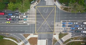 clip-1007942761-aerial-shot-traffic-road-cross-junction