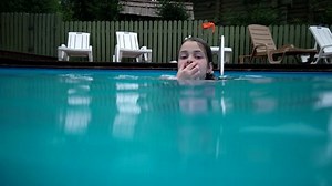 Girl Diving in Swimming Pool. Super Slow Motion. Perfect For Videos About: Swimming, Pools, Summer Fun, Vacation, Getaways, Underwater Footage, Kids, Beating the Heat, and Exercise.