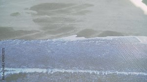 Concrete floor primer. The process of applying primer with a roller and trowel to a concrete floor. Primer for concrete floors to strengthen the surface.