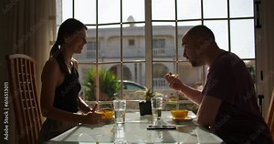 European Gastronomic Delights: A Captivating Couple Indulging in Exquisite Flavors and Intimate Conversations as They Share a Memorable Dinner Experience in the Comfort of Their Home Dining Room.