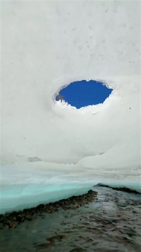In Huzhong, one of China’s coldest towns, the spring thaw reveals stunning under-ice tunnel. While a thick layer of surface ice remains as a frozen “roof,” the Huma river flows beneath, carving hidden channels through crystal-clear meltwater.