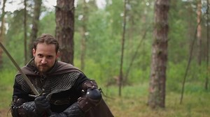 knight in chain mail runs to attack, close-up