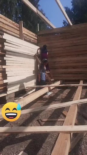 Wooden Plank Stacking Techniques with a Young Helper