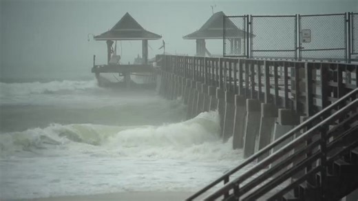 Scenes from Naples Pier as outer bands of Hurricane Idalia bring waves, wind, rain