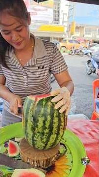 A beautiful female vendor, an expert at peeling pineapples and watermelons 👍 Large, red, sweet, a...