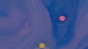 Texture of colored inks simulating a solar system - Free Stock Video