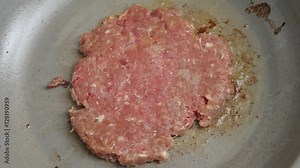 Frying Ground Beef Patty On Pan With Hot Oil. - close up shot