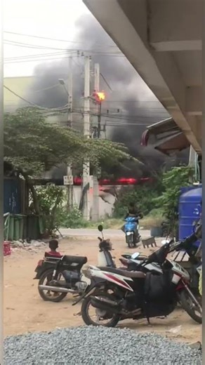 Fire engulfs transformer, explosion causes panic in Cambodia; people flee in disarray.
