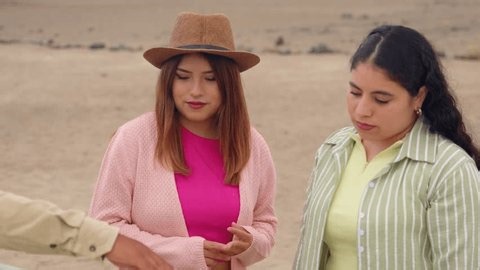 clip-4014884469-young-women-listening-attentively-local-guide-during