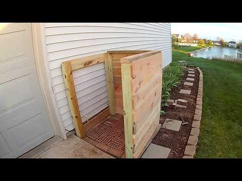 Stop your trash can from blowing over!! DIY Cedar garbage fence storage