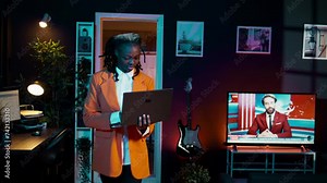 African american girl studying servers providing AI computing resources, learning to program html scripts on artificial intelligence neural network system. Woman uses coding language. Camera B.